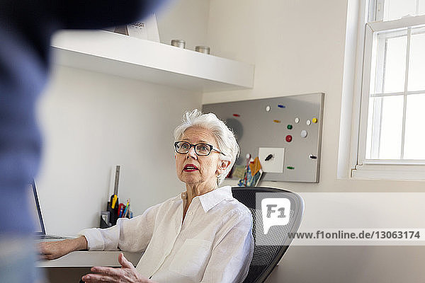 Senior woman working at home office