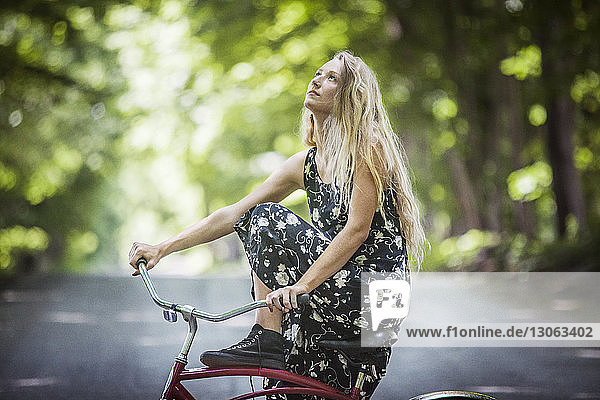 Frau schaut auf  während sie auf dem Fahrrad sitzt