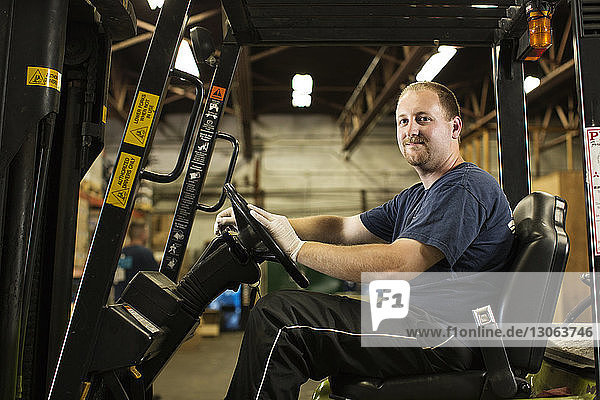 Portrait of mechanic with arms crossed in repair shop