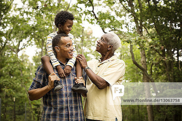 Happy multi-generation family enjoying in forest