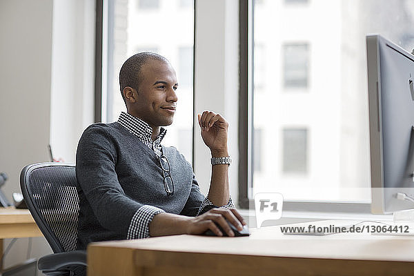 Smiling man working in office