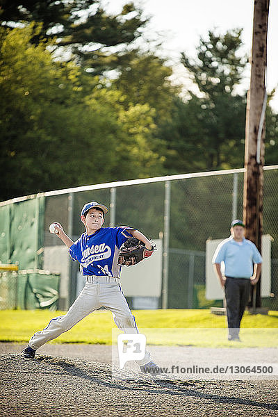 Boy playing baseball on field
