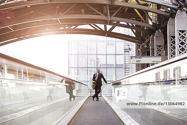 Man standing on escalator at subway station