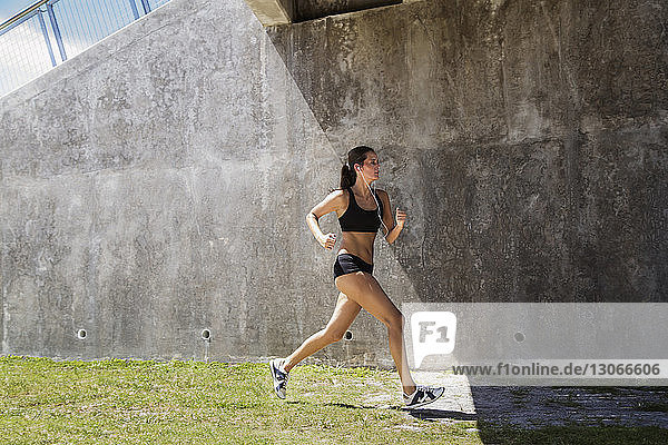 Athlete running against wall on field