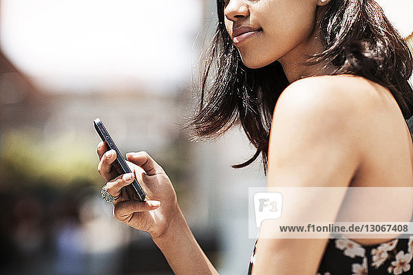 Midsection of woman using smart phone