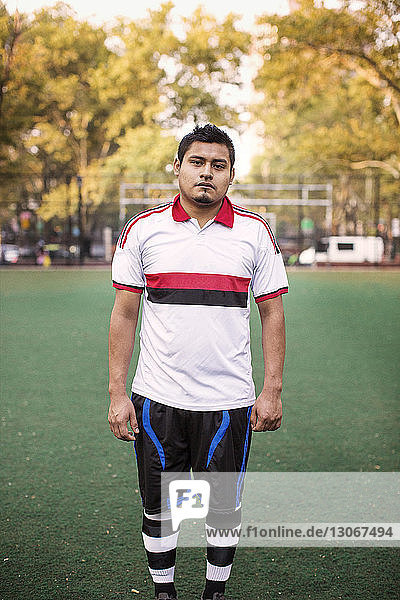 Portrait of sportsman standing at field