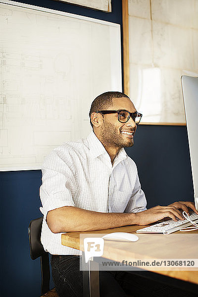 Businessman using desktop computer while working in office