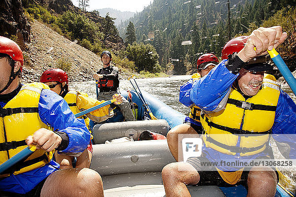Friends kayaking in river