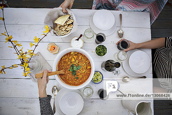 Overhead view of friends having food at table during winter