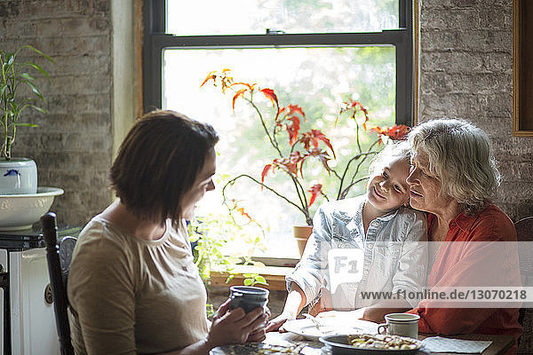 Family talking while having breakfast at home