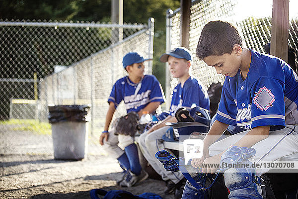 Tired Baseball players sitting on bench dugout