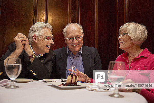 Happy senior friends sitting in restaurant