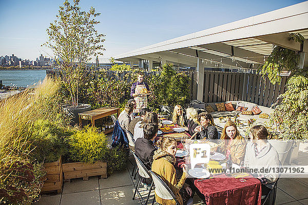 high angle view of friends having meal at outdoor table during garden party