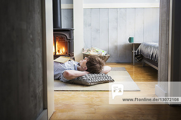 Man lying on floor at home