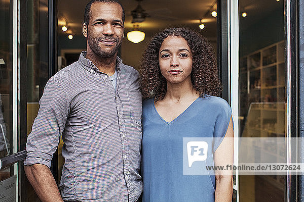Portrait of owners standing at store