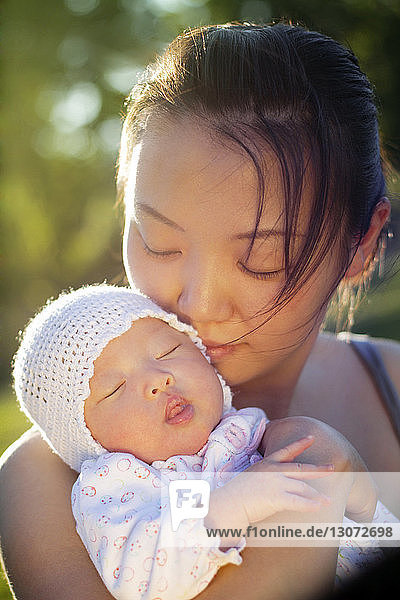 Close-up of woman embracing baby girl