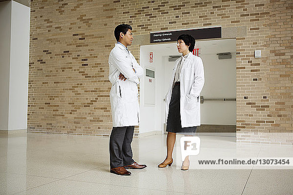 Doctors talking while standing in hospital