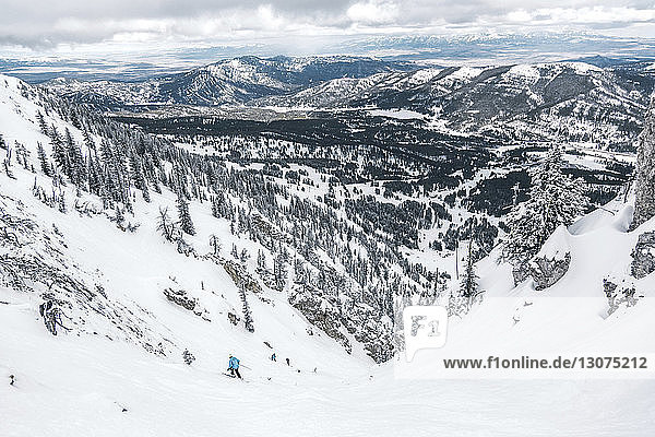High angle view of people skiing on snowcapped mountain