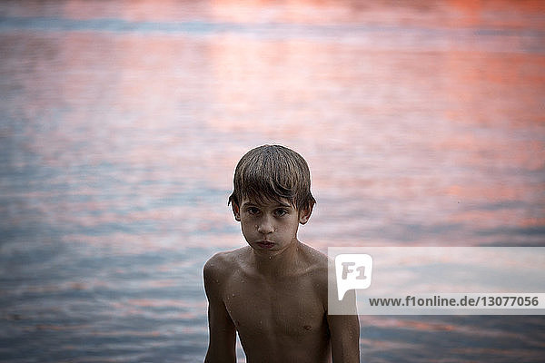 Junge am See bei Sonnenuntergang