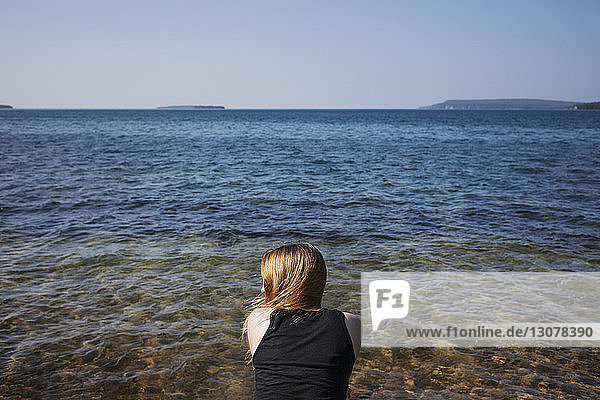 Rückansicht einer Frau gegen das Meer an einem sonnigen Tag