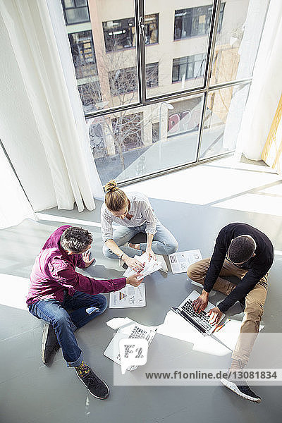 High angle view of business people working by window in office