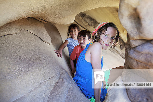 Portrait of siblings sitting in cave