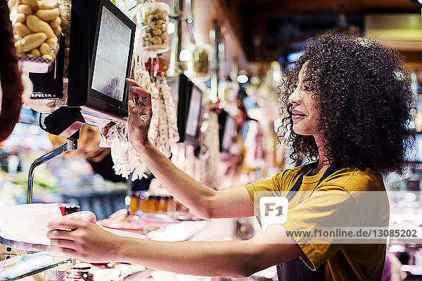 Female owner using desktop computer in shop