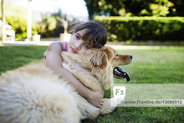 Mädchen ruht sich mit Hund im Hof aus