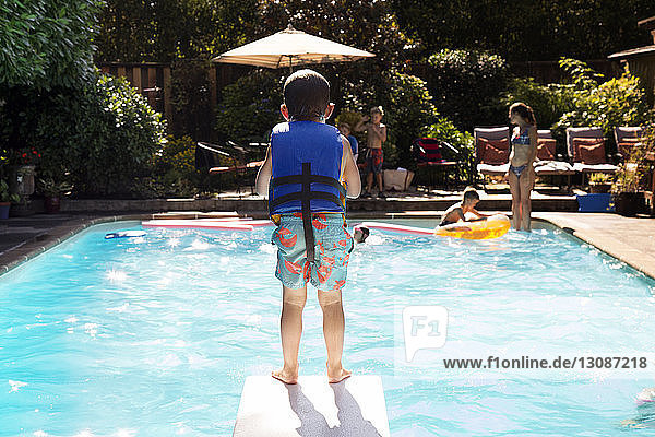 Boy standing on diving board