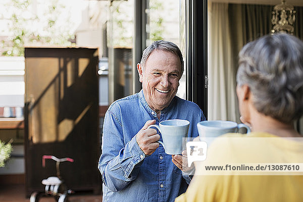 Happy senior couple having coffee on porch