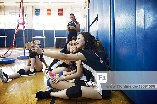 Teenager-Mädchen klicken beim Entspannen vor Gericht auf Selfie