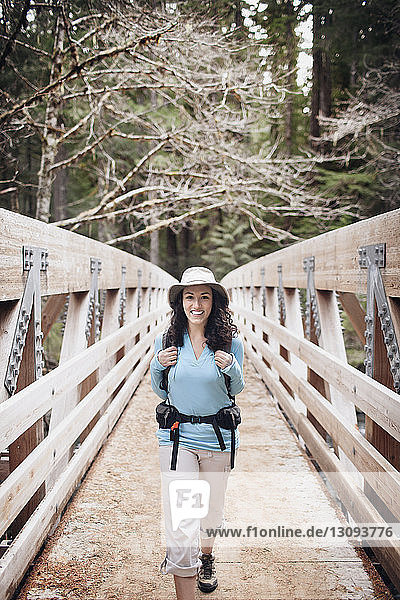 Young woman on wooden bridge