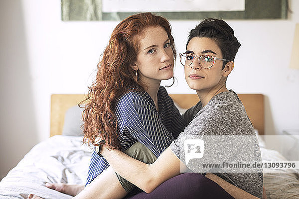 Portrait of lesbian couple relaxing on bed at home