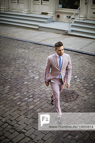 High angle view of businessman walking on street