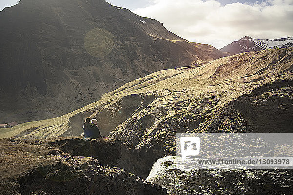 Couple sitting on mountain