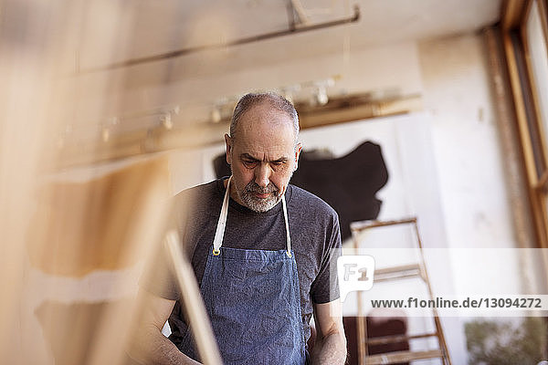 Senior male artist working in workshop