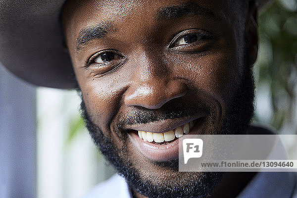 Close-up portrait of smiling businessman in creative office