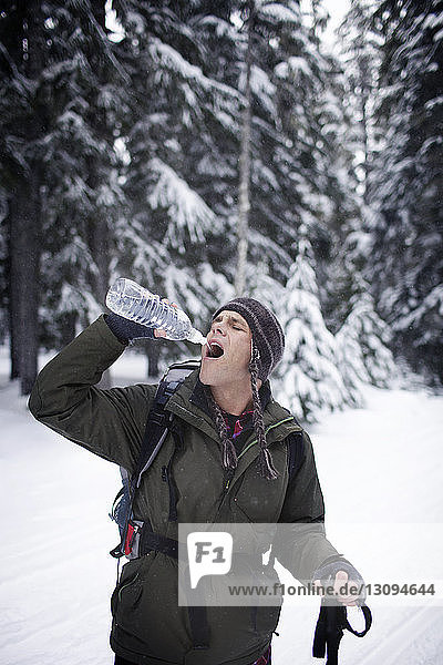 Hiker drinking water in forest