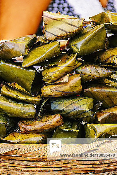 Close-up of food wrapped in banana leaves on basket