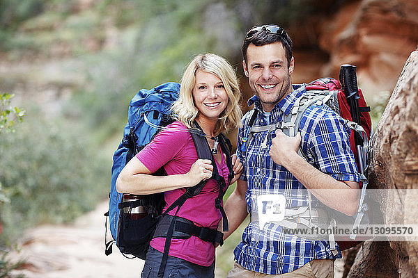Portrait of couple with backpacks during hiking
