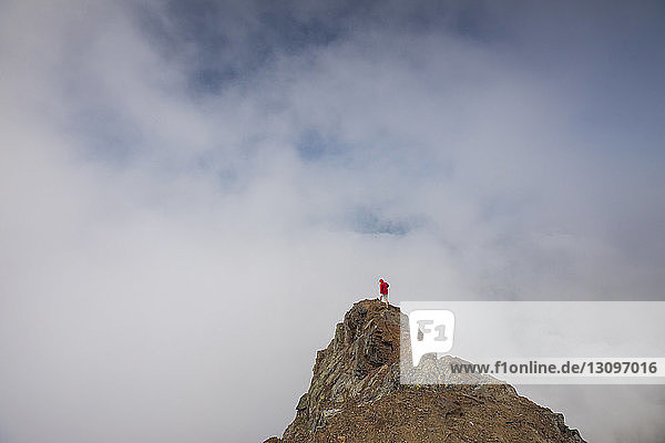 Hochwinkelaufnahme eines Wanderers  der auf dem Cheam Peak vor bewölktem Himmel steht