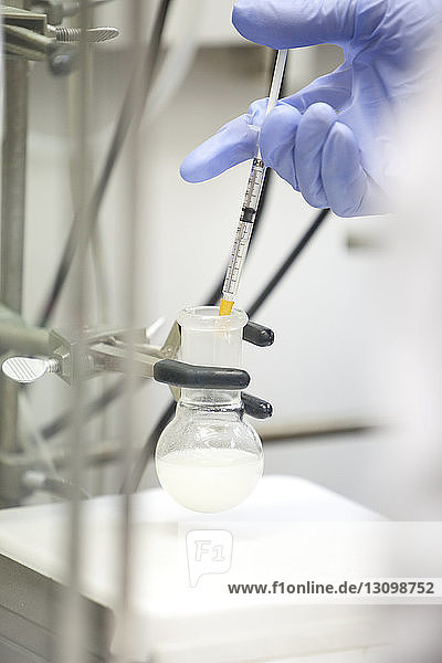 Scientist using pipette in laboratory