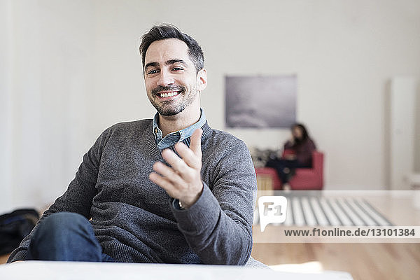 Close-up of smiling businessman sitting in office