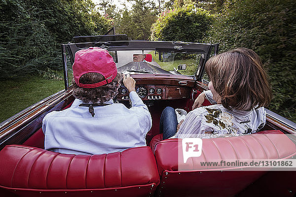 Rear view of senior couple sitting in car