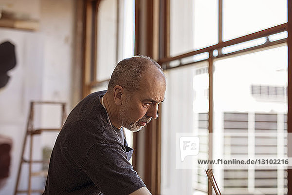 Senior male artist in workshop