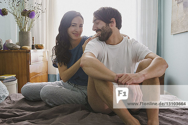 Portrait couple relaxing on bed