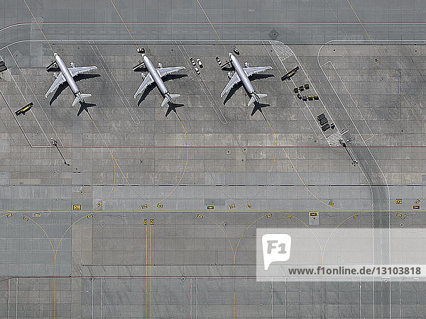 Aerial view airplanes parked on tarmac at airport