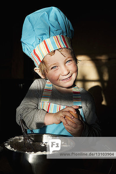 Portrait cute girl in chefs hat baking