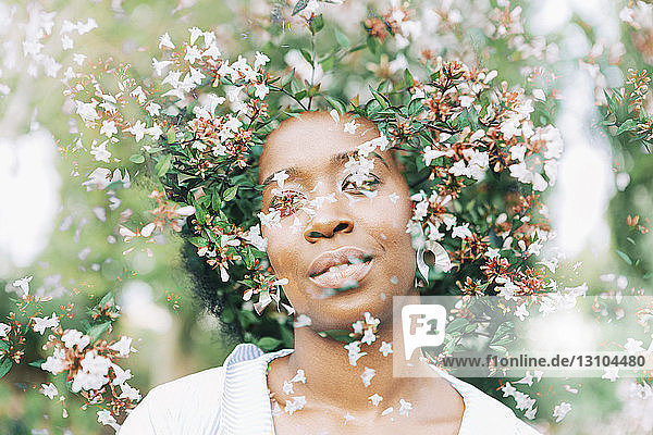 Multiple exposure young woman and tree with pink blossoms