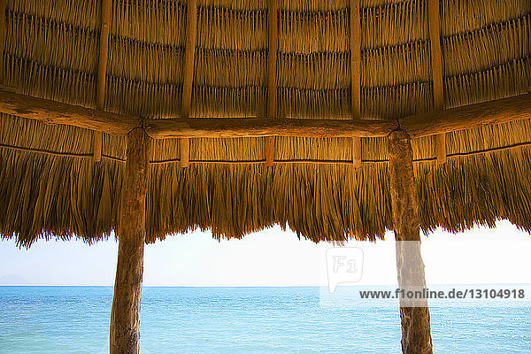 Eine typische Hütte mit Strohdach an einem Strand in der Karibik